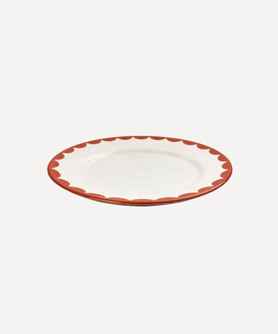 Cascos Side Plate in Rust Red, scalloped ceramic — styled on a table