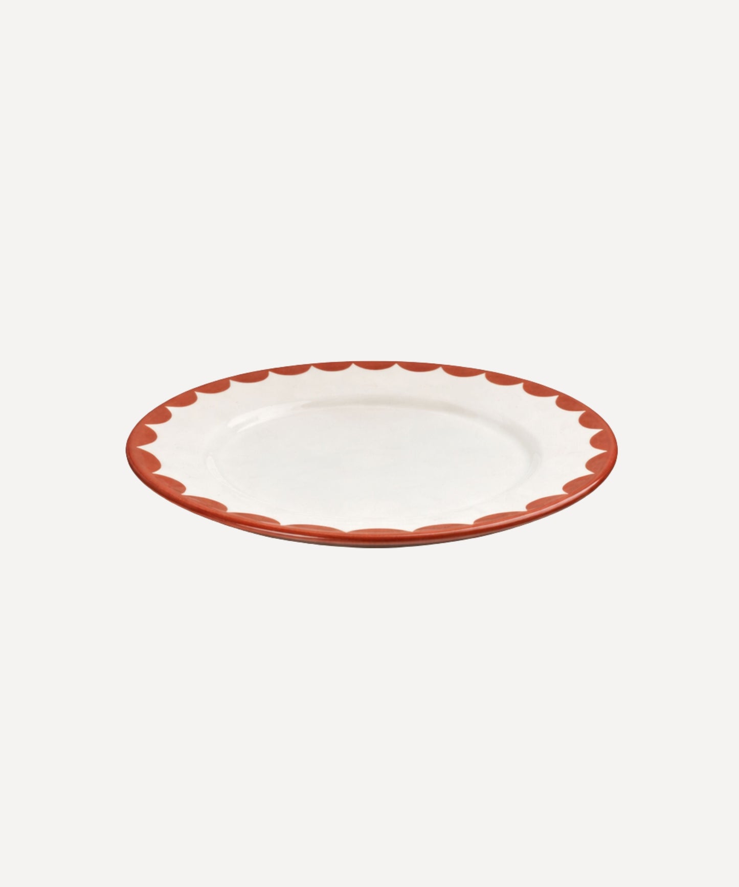 Cascos Side Plate in Rust Red, scalloped ceramic — styled on a table