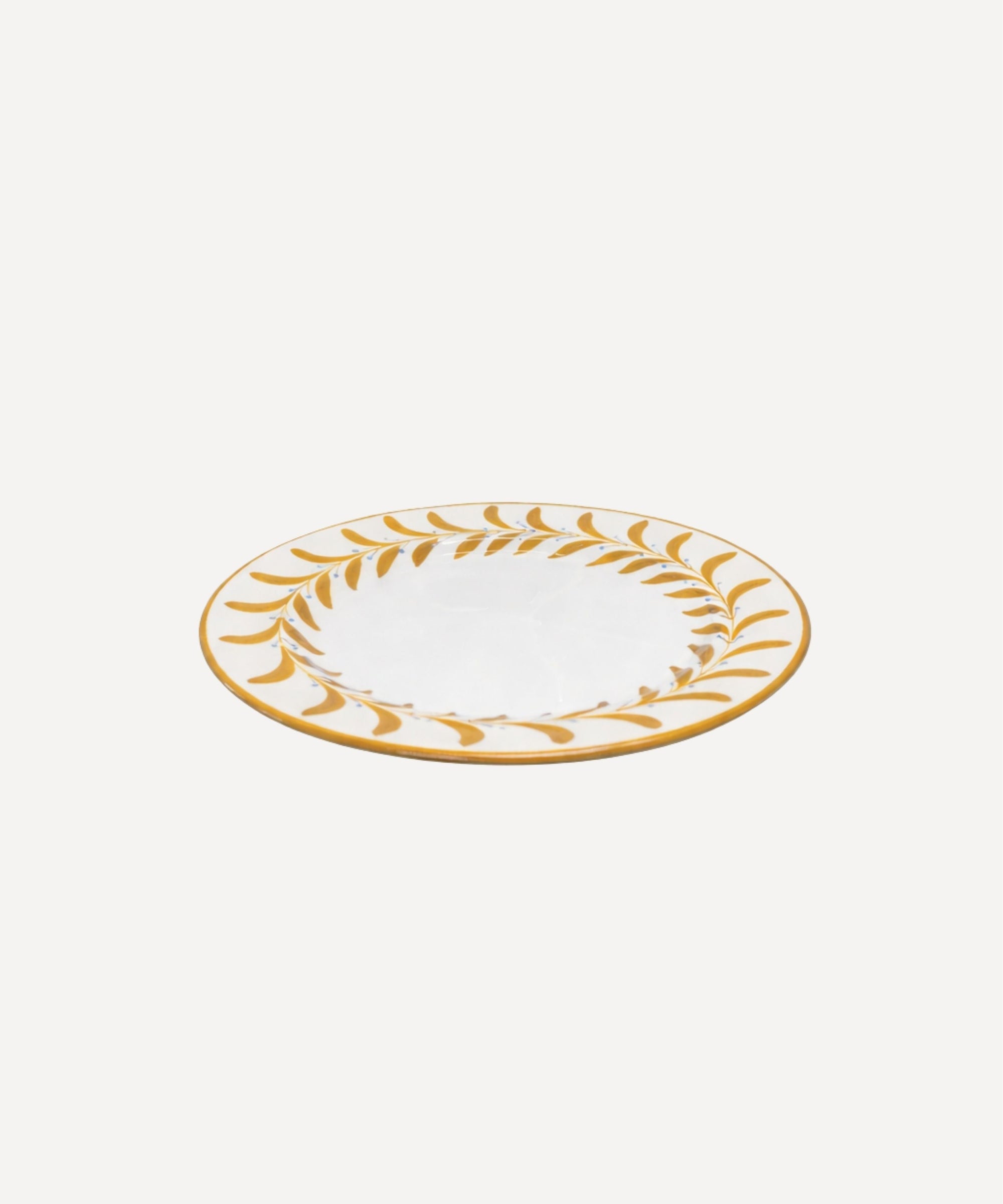 Helecho Side Plate Golden Yellow top-down view — fern wreath on white ground