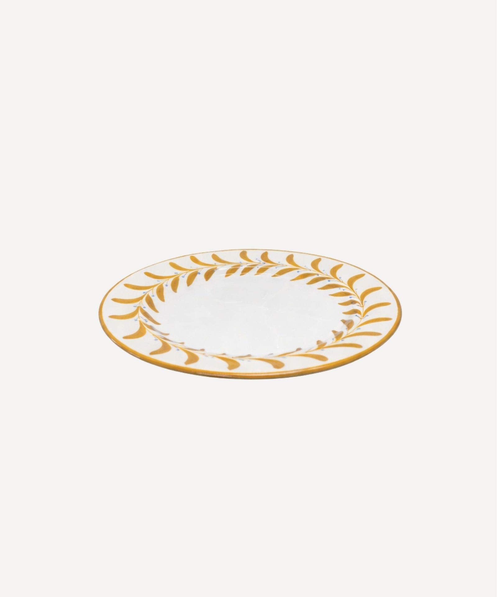 Helecho Side Plate Golden Yellow top-down view — fern wreath on white ground