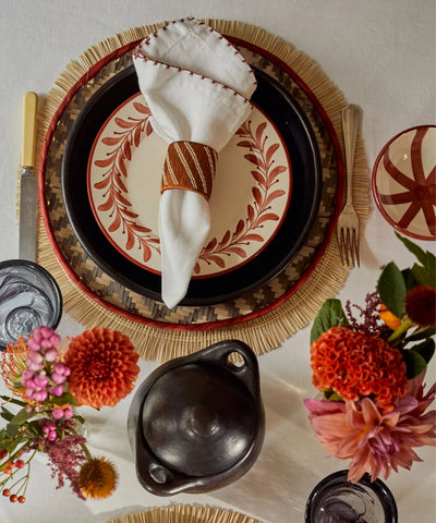 Helecho Side Plate Rust Red tablescape — hand-painted Colombian ceramic with bread