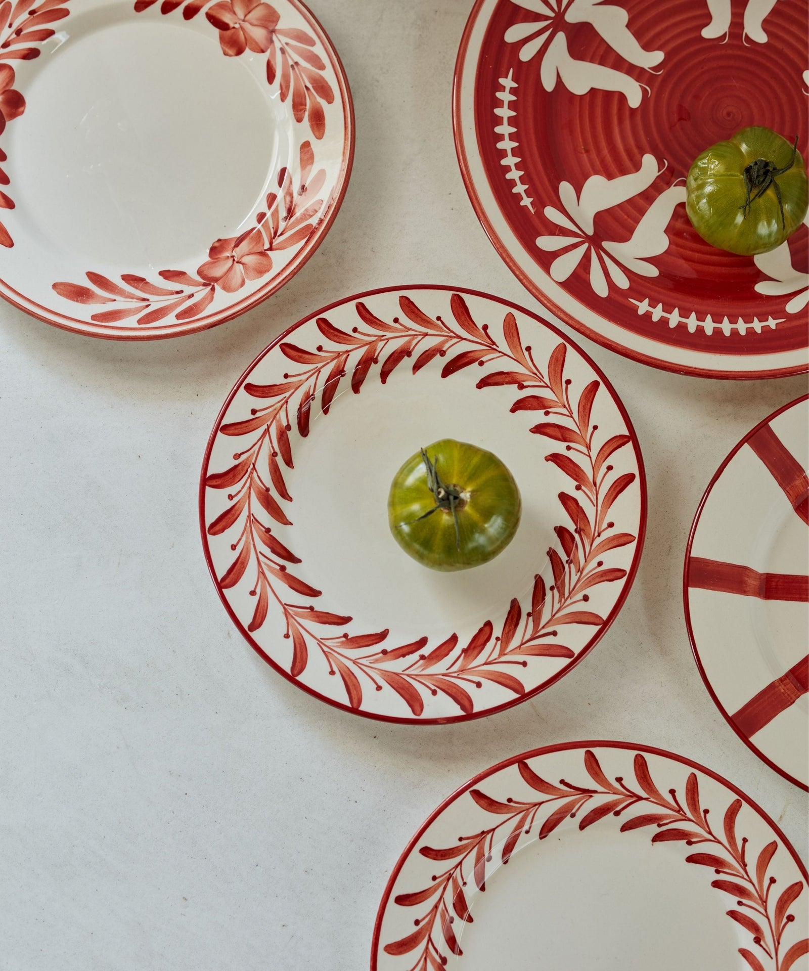 Helecho Side Plate Rust Red lifestyle — warm terracotta toned ceramic table setting