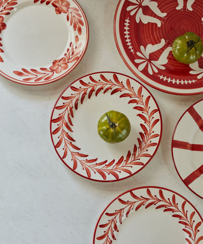 Helecho Side Plate Rust Red lifestyle — warm terracotta toned ceramic table setting