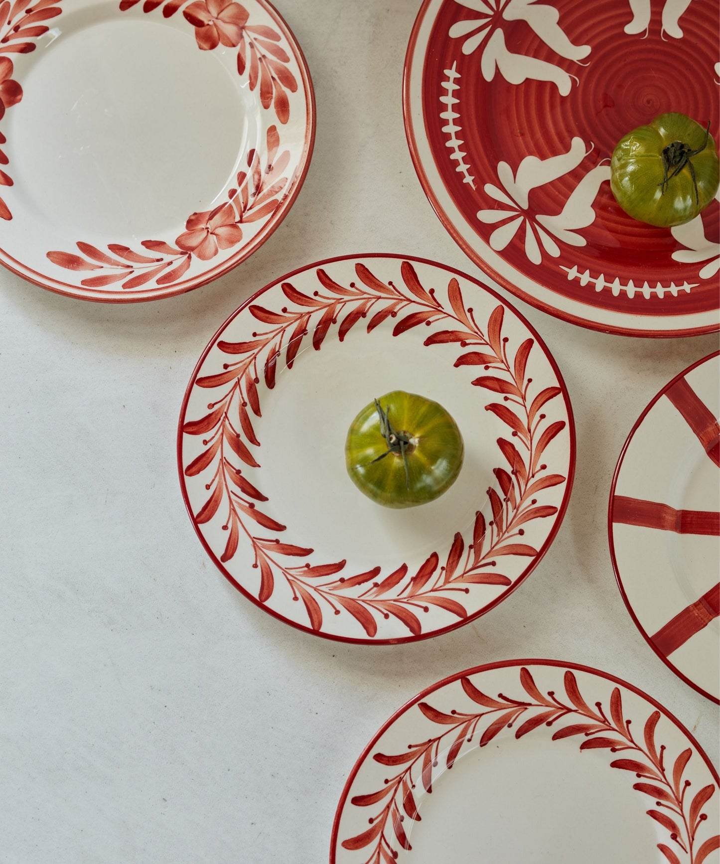 Helecho Side Plate Rust Red lifestyle — warm terracotta toned ceramic table setting
