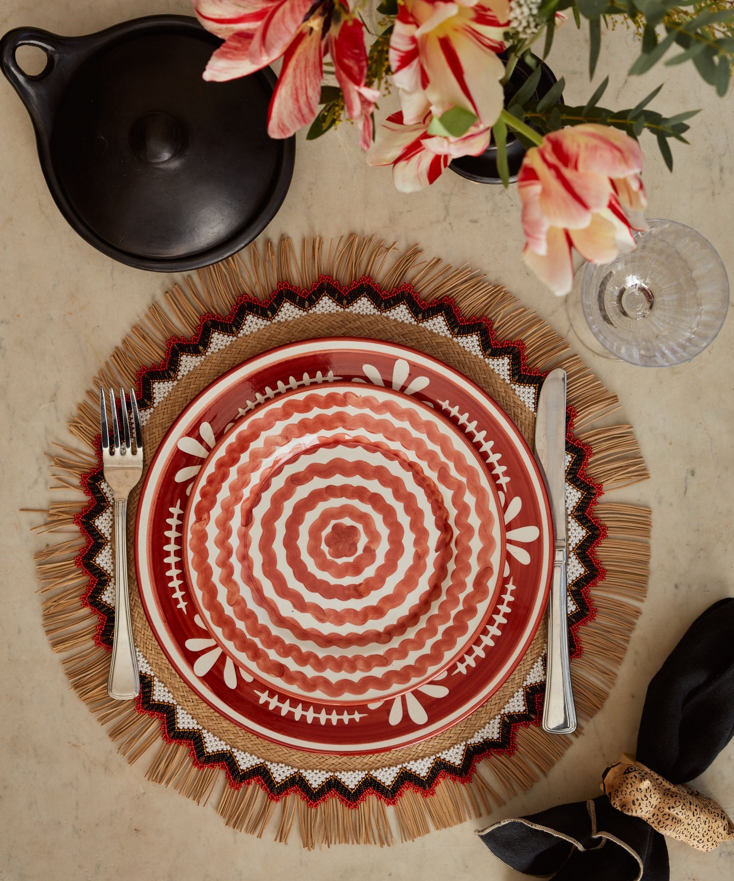 Ondas Side Plate in Rust Red, rippled ceramic — on a table setting