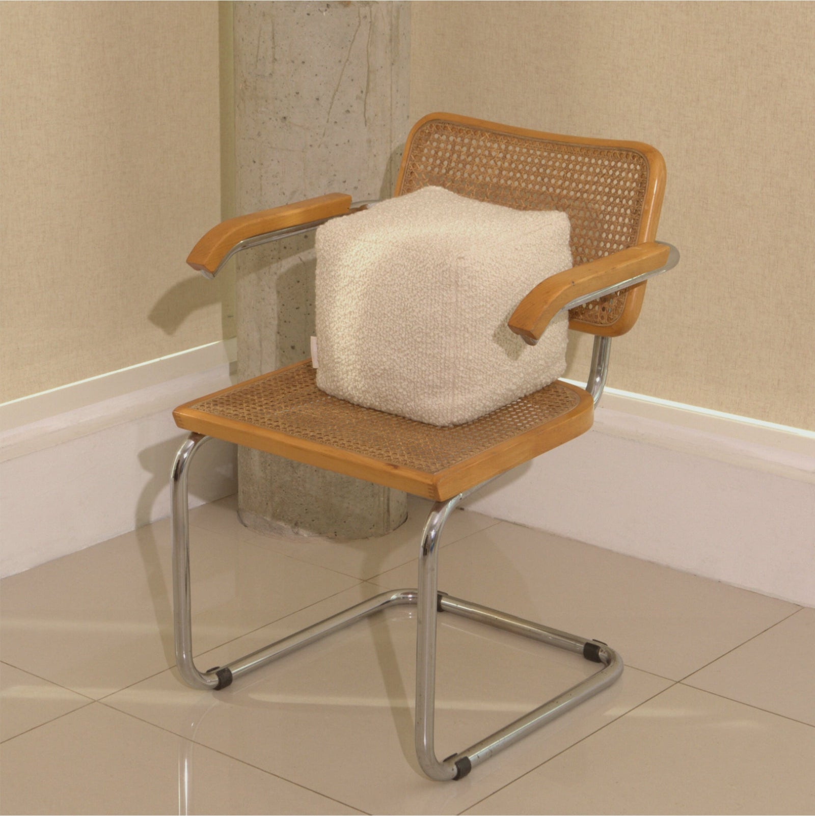 Cream wool bouclé cube cushion on chair - handmade in UK