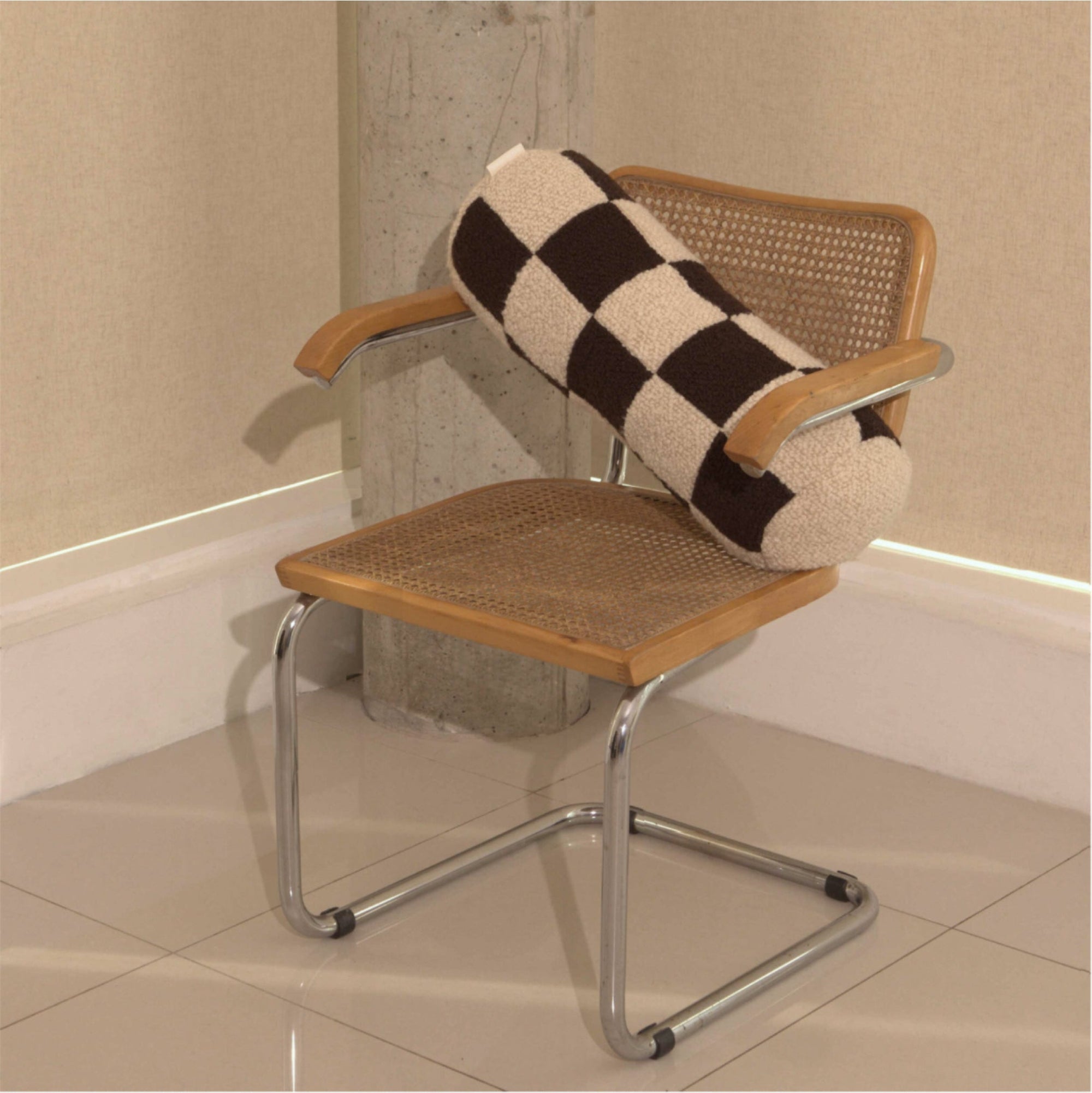 Cream and brown wool bouclé checkered bolster cushion on chair - handmade in UK