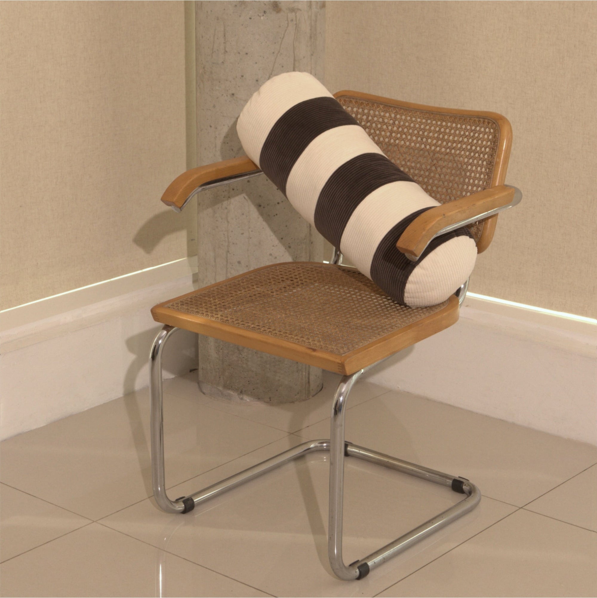 Cream and brown cotton corduroy striped bolster cushion on chair - handmade in UK