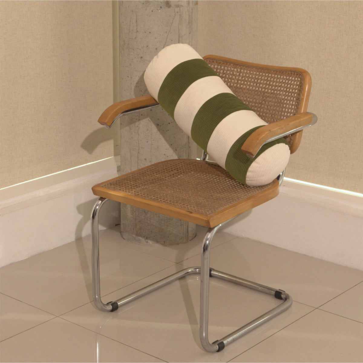 Cream and green cotton corduroy striped bolster cushion on chair - handmade in UK