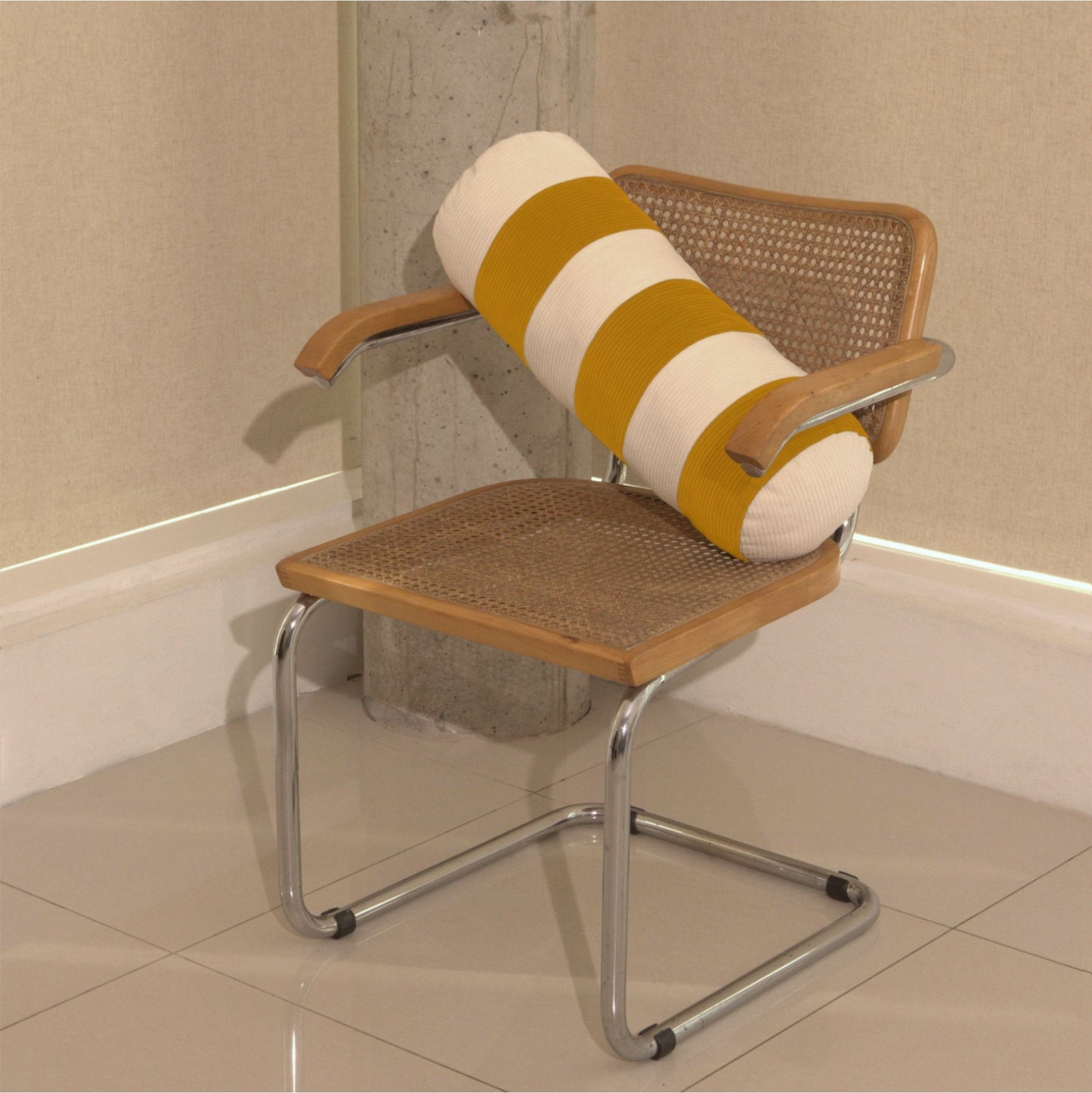 Cream and yellow cotton corduroy striped bolster cushion on chair - handmade in UK