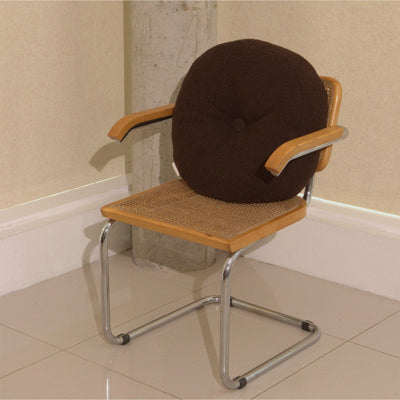Brown wool bouclé round cushion on chair - handmade in UK