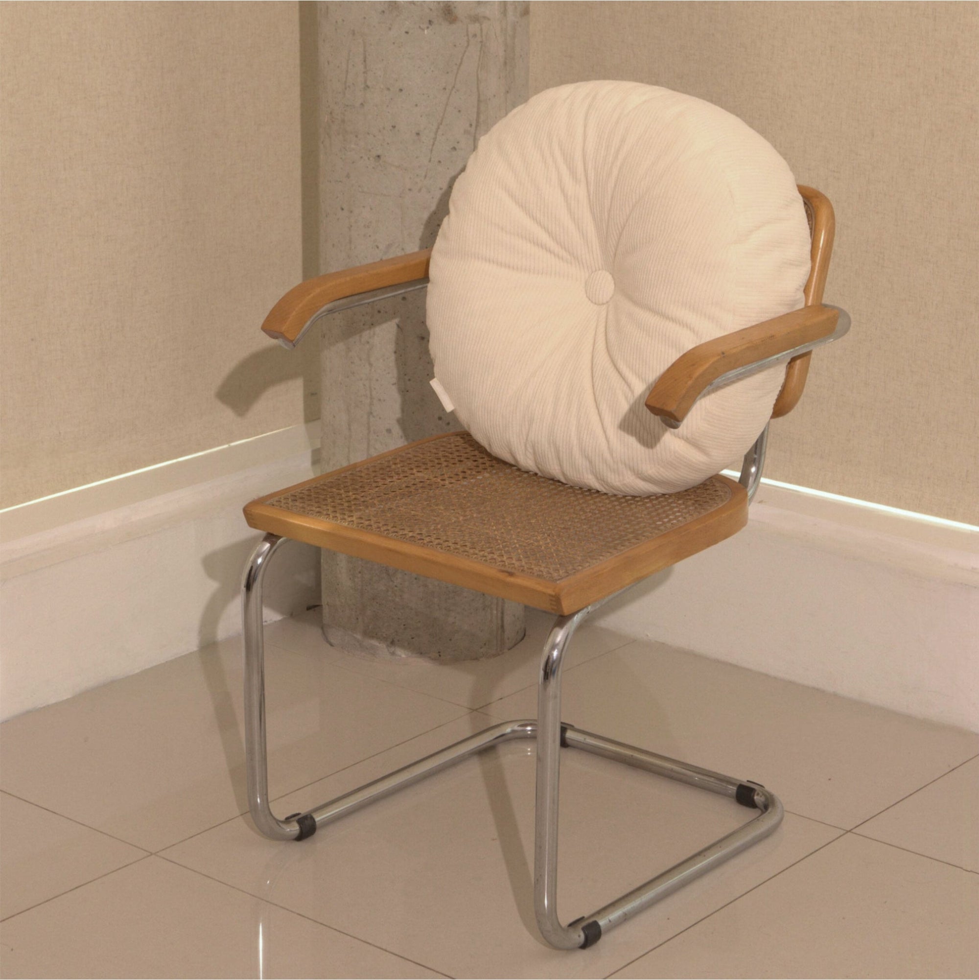 Cream cotton corduroy round cushion on chair - handmade in UK