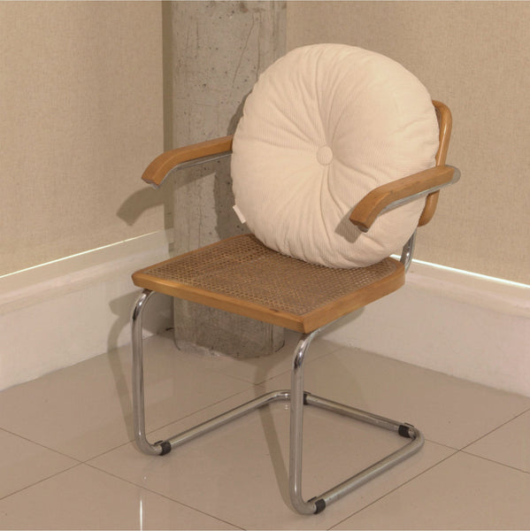 Cream cotton corduroy round cushion on chair - handmade in UK