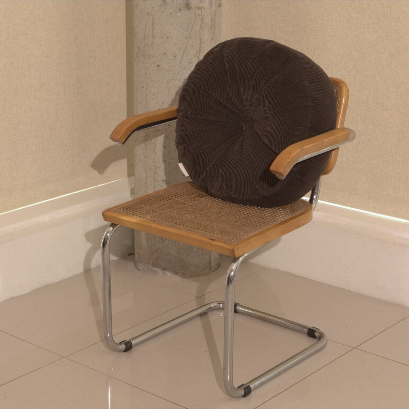 Brown cotton corduroy round cushion on chair - handmade in UK