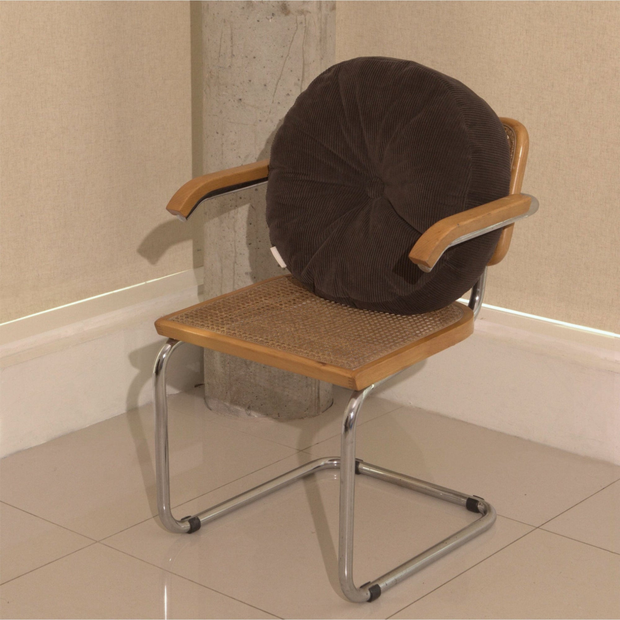 Brown cotton corduroy round cushion on chair - handmade in UK