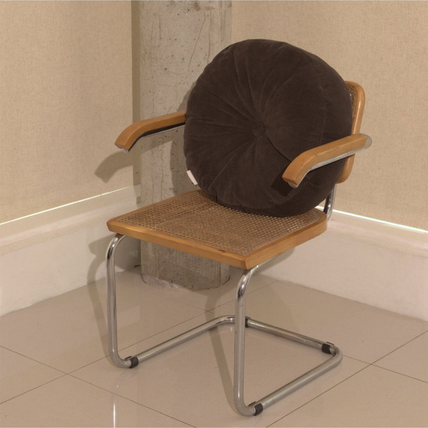 Brown cotton corduroy round cushion on chair - handmade in UK