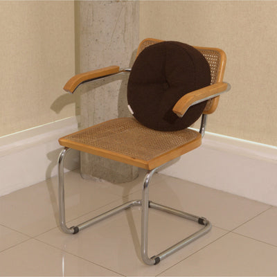 Brown wool bouclé round cushion on chair - handmade in UK