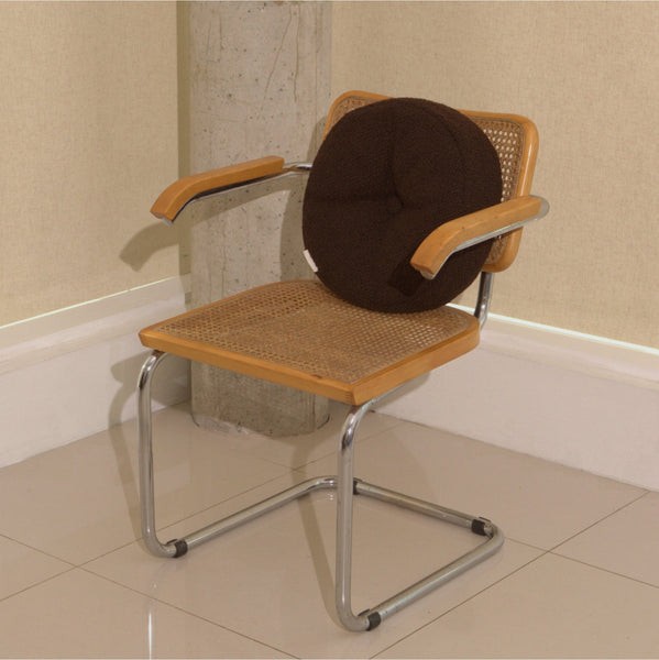 Brown wool bouclé round cushion on chair - handmade in UK