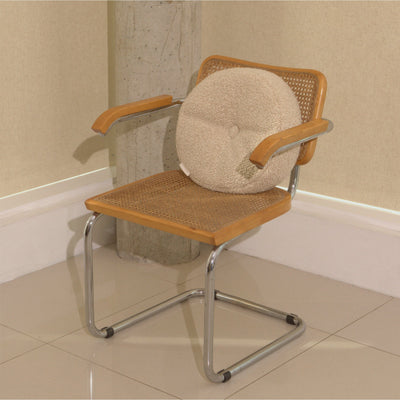 Cream wool bouclé round cushion on chair - handmade in UK