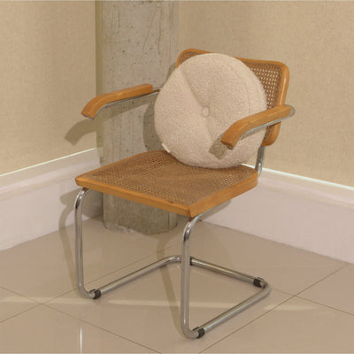 Cream wool bouclé round cushion on chair - handmade in UK