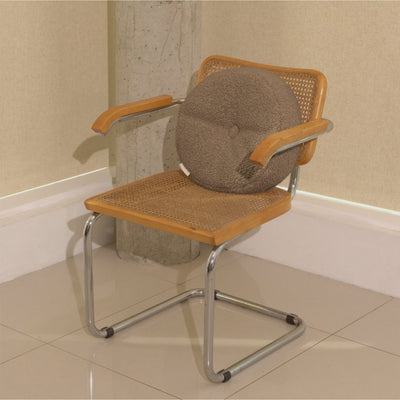 Beige wool bouclé round cushion on chair - handmade in UK