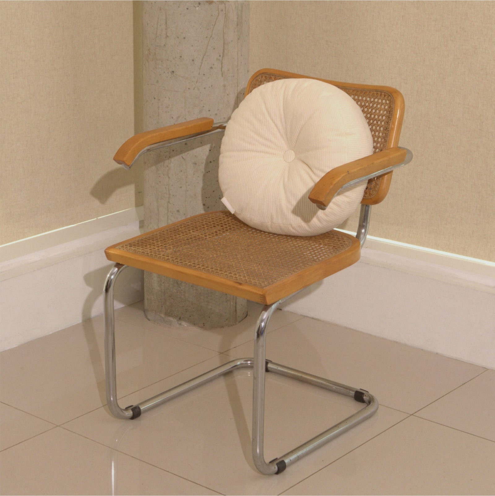 Cream cotton corduroy round cushion on chair - handmade in UK