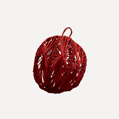 Star-motif iraca palm Christmas bauble in red, handwoven in Usiacurí, Colombia