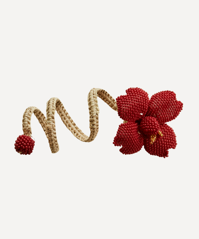 Corazon napkin ring in marsala, hand-beaded heart, holding a folded napkin