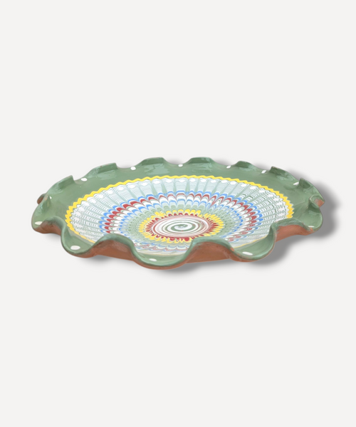 Decorative ceramic plate with colorful concentric circle design on a white background