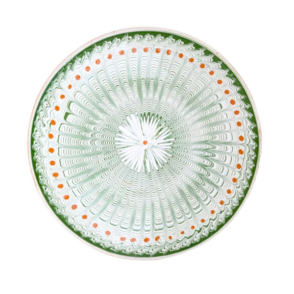 A large serving plate with a pattern in green and ginger detail, featuring a central motif surrounded by a border with a similar design.