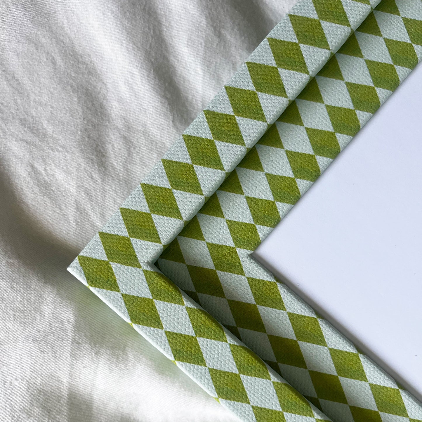 Green and blue fabric frame detail, showing texture and colour