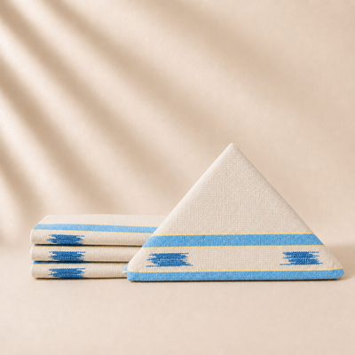 Four coctaik napkins with blue and white patterns on a beige background