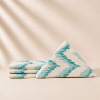 Four turquoise napkins on a beige background