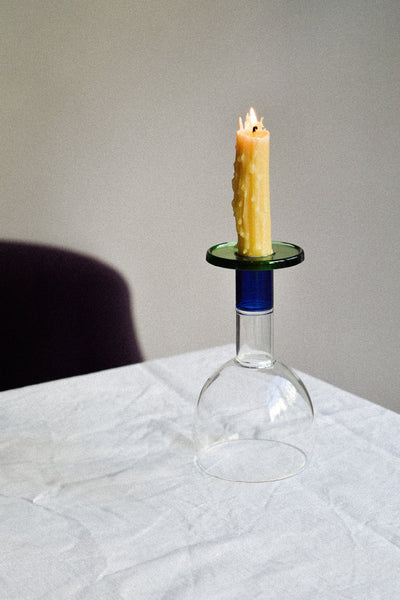 Wine candle glass with green and blue accents, featuring a candle on top and showcasing a taverna-style design.