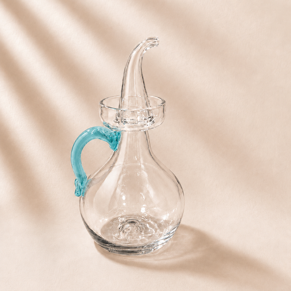 Olive Cruet with a blue handle on a beige background