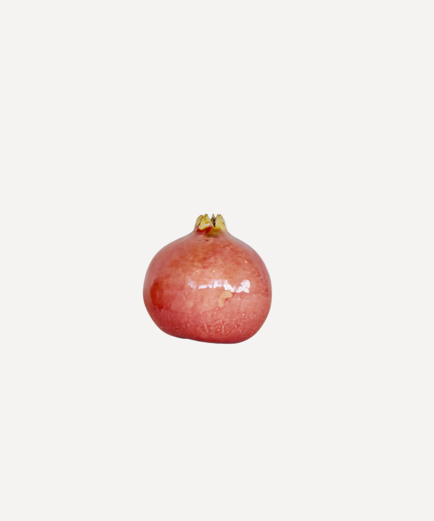 Handcrafted ceramic pomegranate ornament in red glaze by Marla Primrose – decorative artisan pottery for home or gift.