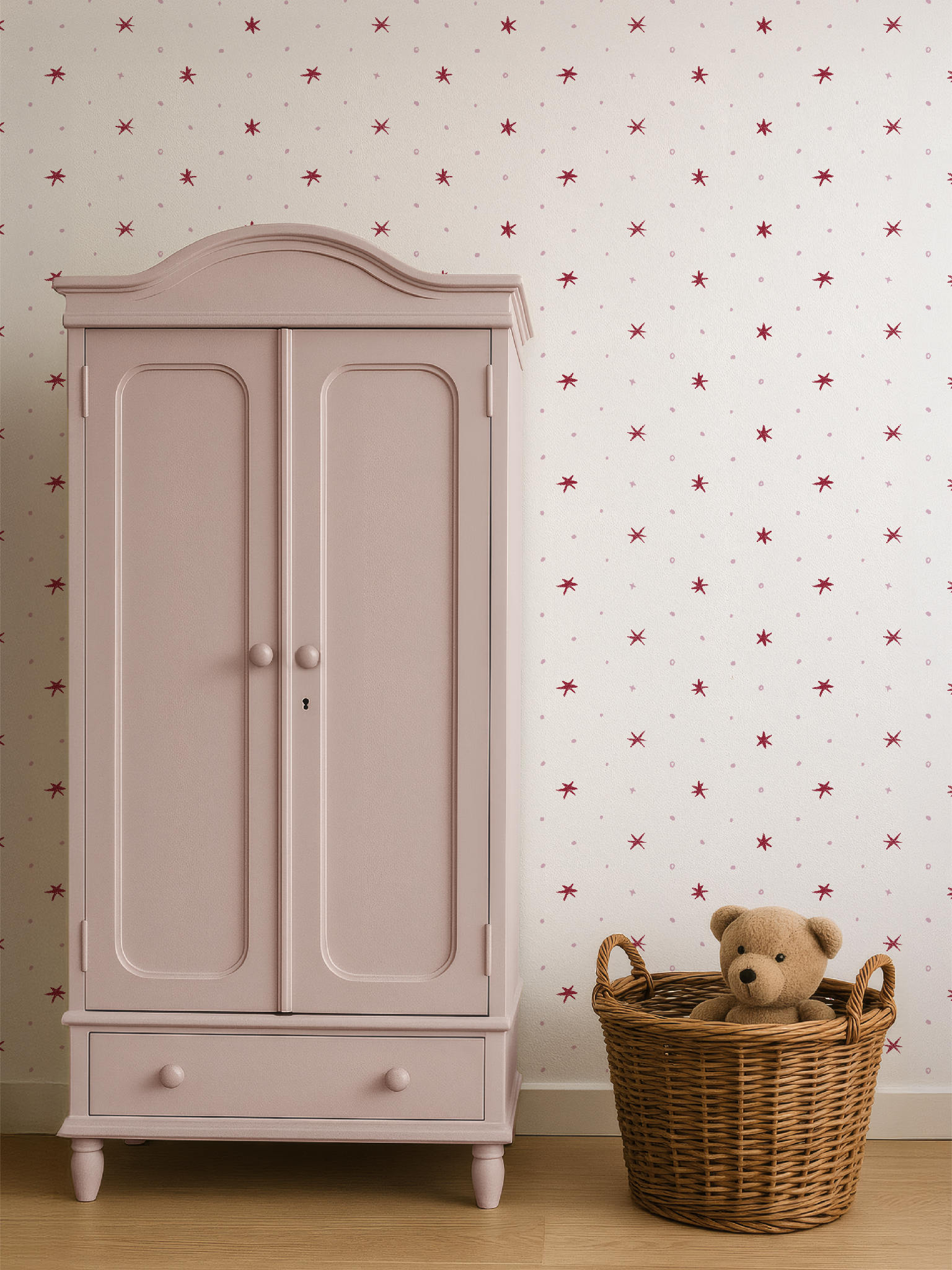 Pink wardrobe with a teddy bear in a basket against a star-patterned wallpaper by Lizzet Frausto.