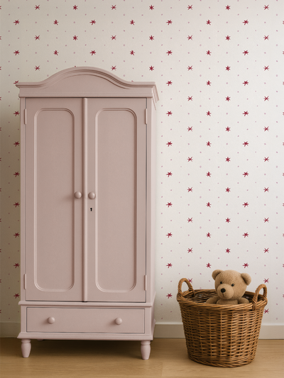 Pink wardrobe with a teddy bear in a basket against a star-patterned wallpaper by Lizzet Frausto.