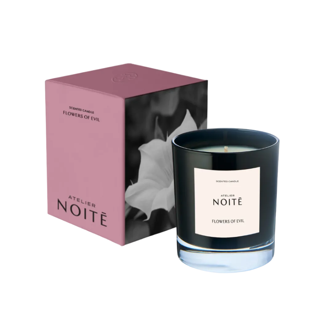 Black candle with 'Atelier Noité' label and pink packaging on a white background