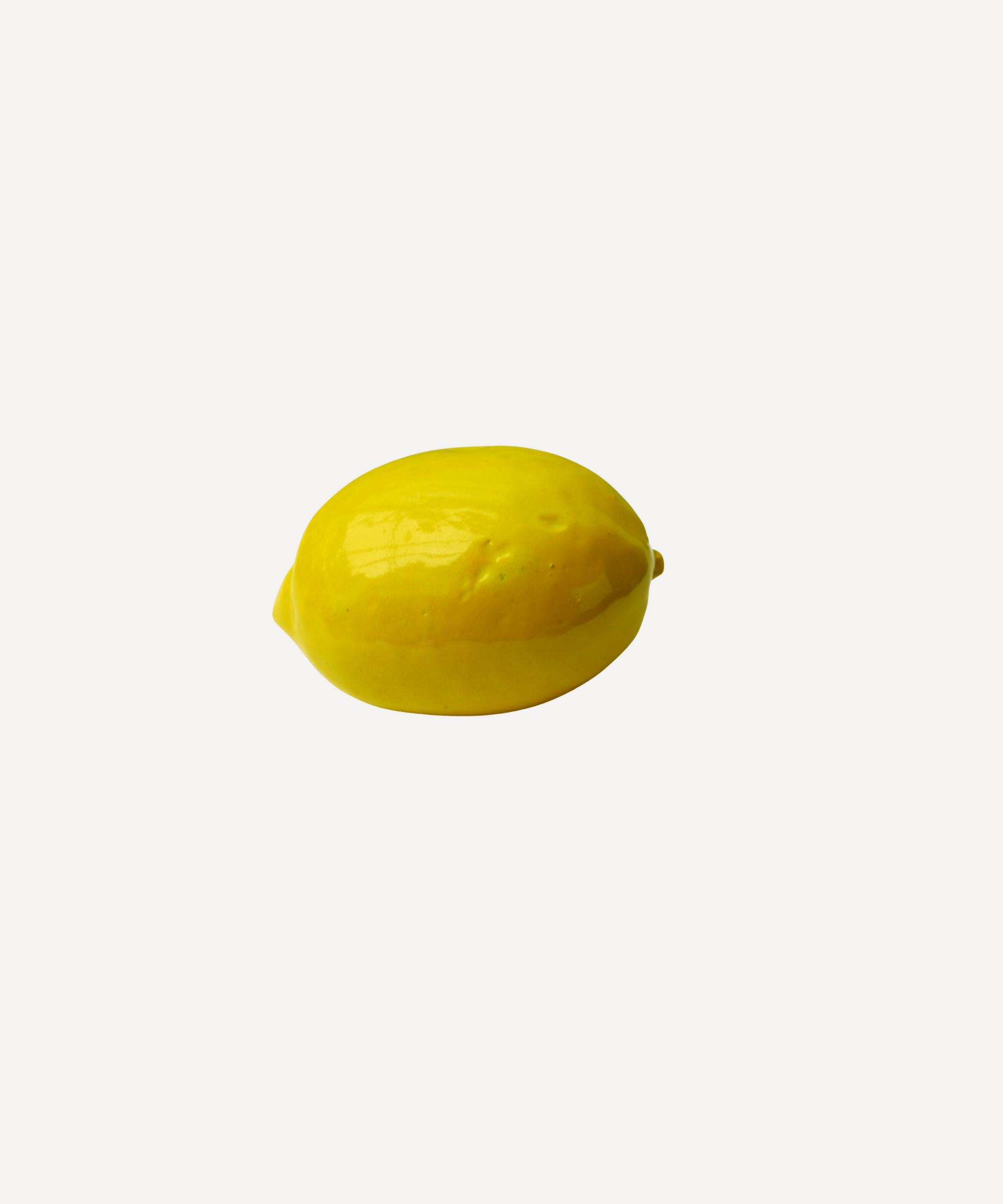 Handmade ceramic lemon with glossy glaze by Marla Primrose – realistic artisan stoneware fruit decor handcrafted in the UK.