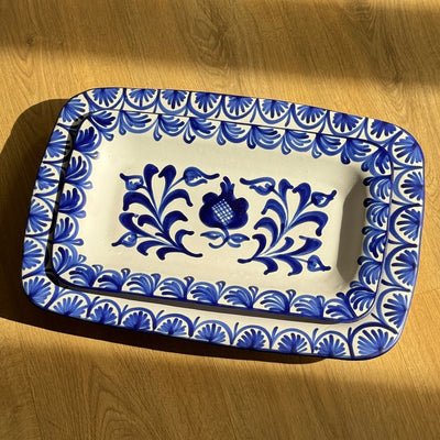 Rectangular ceramic tray with blue floral patterns on a wooden surface - lifestyle