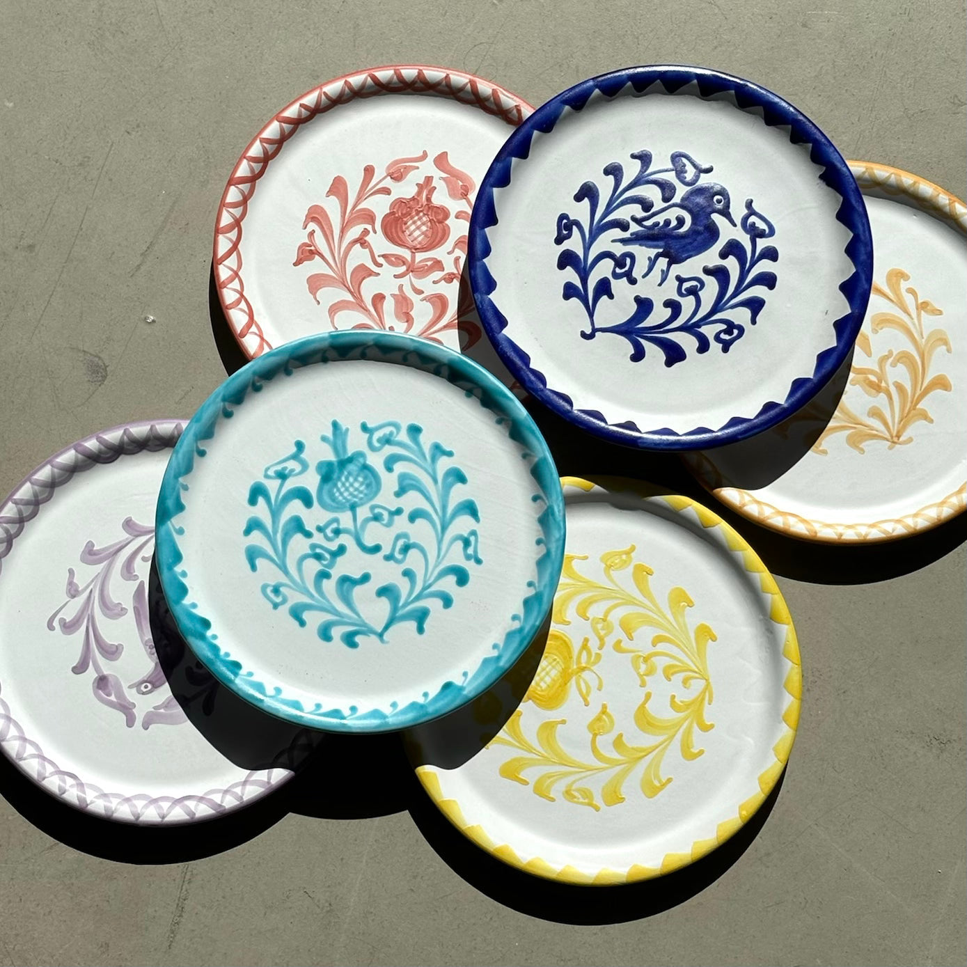 Set of decorative ceramic plates with intricate patterns on a gray surface - lifestyle