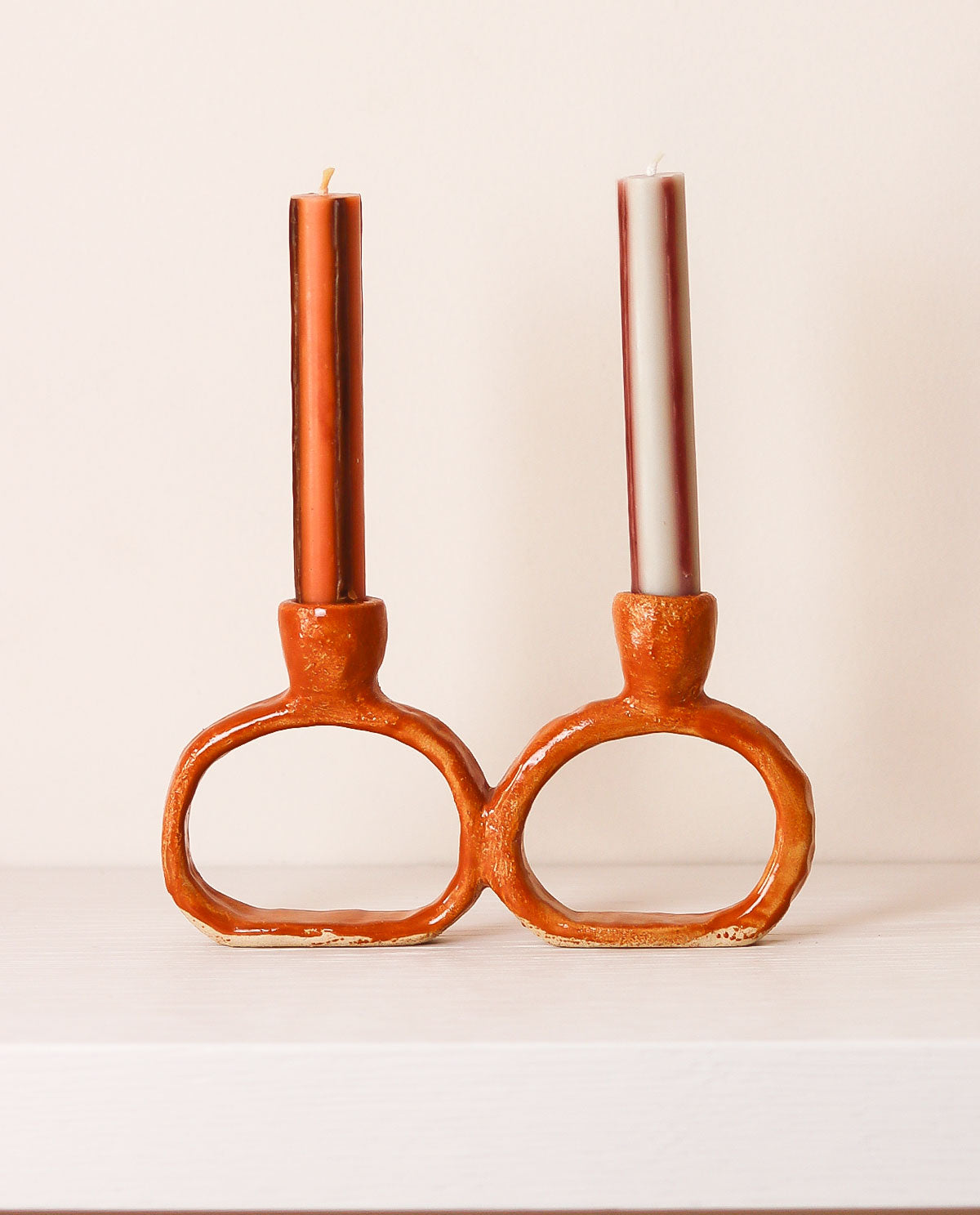 orange ceramic candle holder with candles on a white background