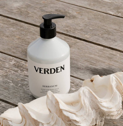 Herbanum Hand and Body Balm next to shell