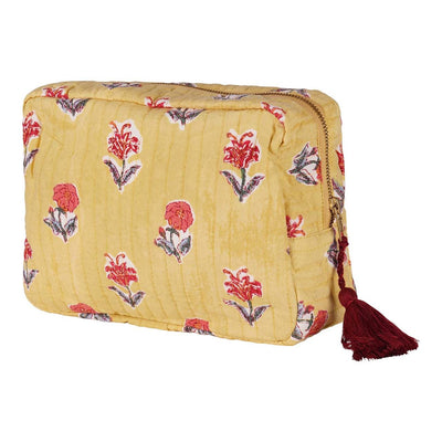A yellow cotton vanity pouch with red floral hand block printing and a dark red tassel.