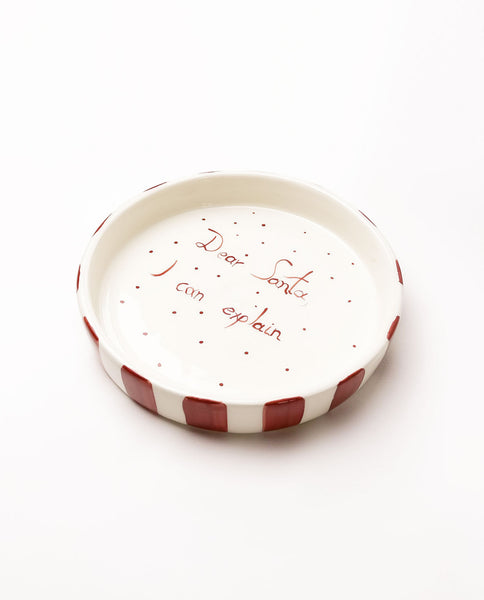 Small ceramic plate with red text on a white background