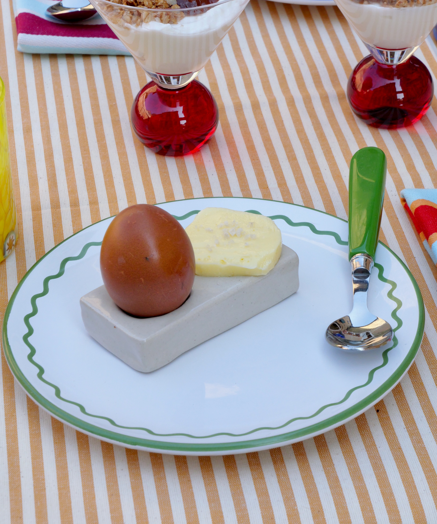 Handmade rectangular stoneware egg cup in a natural finish. Artisanal design with a minimalist aesthetic, perfect for serving soft-boiled eggs. Unique handcrafted texture and earthy tone, ideal for rustic or modern kitchen décor.