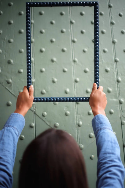Hands holding an Inky Blue Bobbin Frame