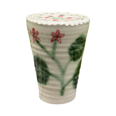 Ceramic vase with floral design on a white background
