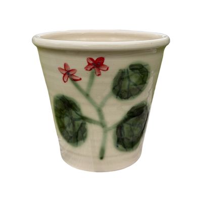Ceramic pot with floral design on a white background
